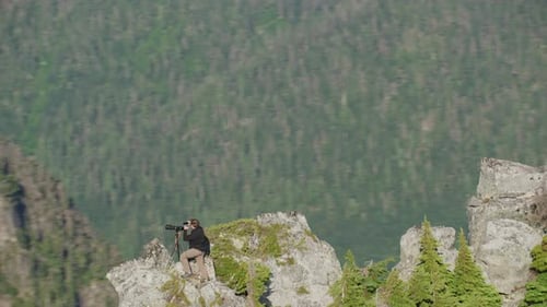 Photographer takes shaka selfie with phone on mountain ridge with epic view, Tim Durkan wide trackin