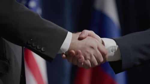 Close-Up of Russian and American Politicians Shaking Hands at Press Event
