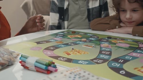 Children and Adult Playing a Board Game Together