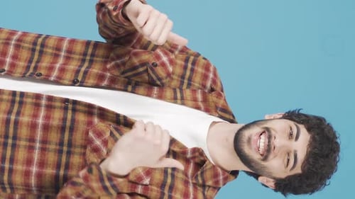 Vertical Video of Dancing man is having fun doing various free dances on the house wall.