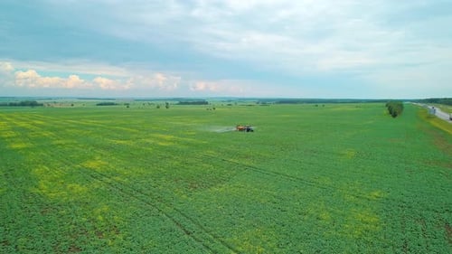 Aerial Panoramic View of a Tractor Machine Spraying the Field with Pesticides Farm Machinery
