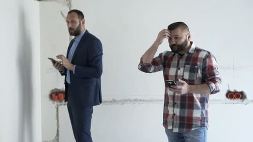 Men Analyzing Project at New Home