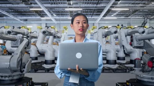 Woman Using Laptop with Robotic Arms