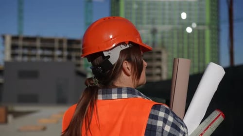 Woman Engineer Talking on Phone at Construction Site