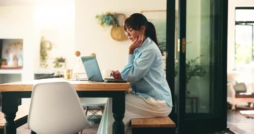 Woman Working at Laptop Stretching in Bright Home