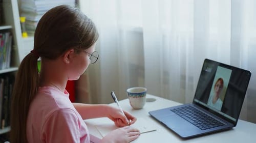 Girl Attends Online School Lesson with Laptop
