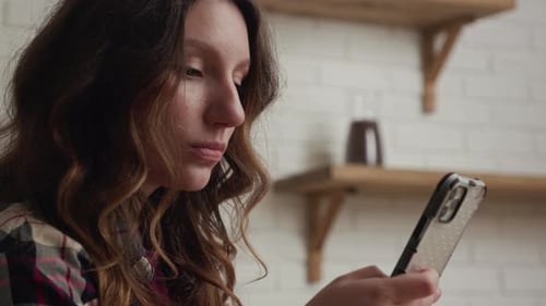 Woman Using Smartphone Indoors in Close-Up Shot