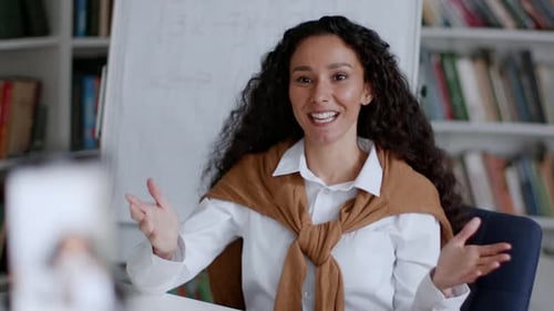 Young Positive Middle Aged Lady Tutor Recording Video Lesson on Smartphone Waving Hand and Smiling