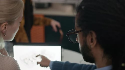 Diverse Team of Architects Analyzing Modern Building Plan on Projector