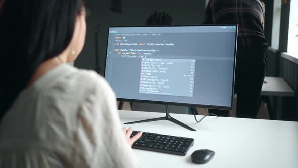 woman programmer writing code and creating new software or website ...