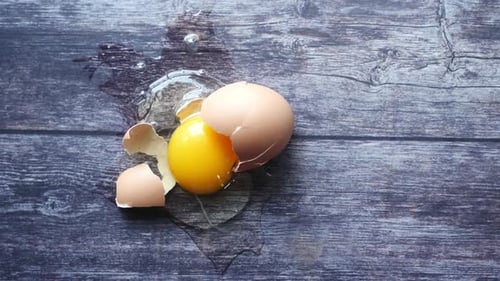 Fresh Broken Egg on a Wooden Table