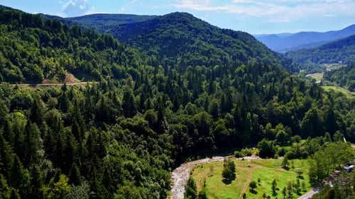 Scenic view of lush mountains and river. Lush green mountains surround a winding river under