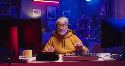Cheerful Handsome Stylish Old Man DJ Working at Home Studio Making Music on Mixer Console Listening
