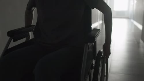 Person in Wheelchair Moves Down Hallway