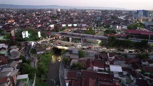 Yogyakarta Cityscape in Sunset with Train and Rush Hour Bakcground