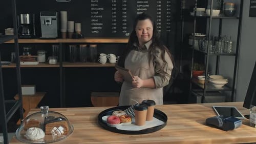 Girl With Disability At Work In Cafe