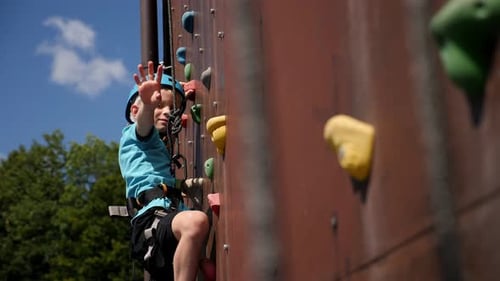 Young Boy Enjoying Rock Climbing Activity Outdoors