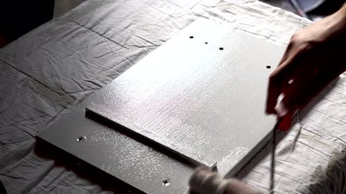 Hand Painting Wood Surface with Roller Indoors