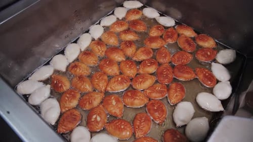 Golden Meat Pies Frying In Hot Oil