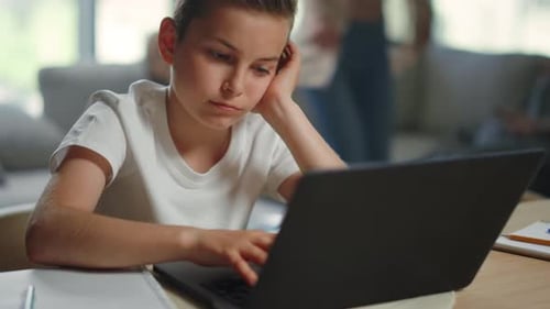 Boy Using Laptop Computer at Home, Indoor Setting