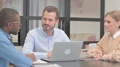 Mixed Race Entrepreneurs Discussing Business in Office
