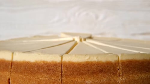 Plain Cheesecake Cake Closeup Spinning on Turntable Cakes in a Coffee Shop Many Slices of Classical