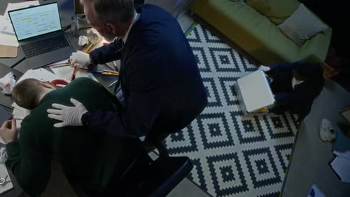 Diverse Couple of Forensic Experts Working Together at Murder Scene in Office