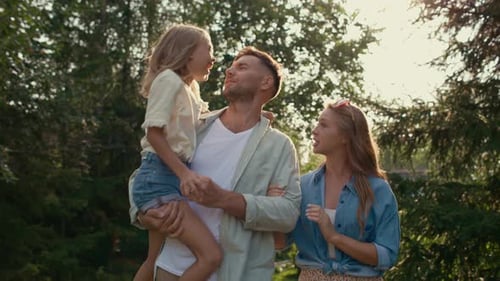 Playful family bonding in the sunlit garden on a beautiful summer day