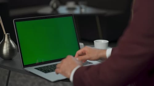 Executive Typing at Green Screen Laptop
