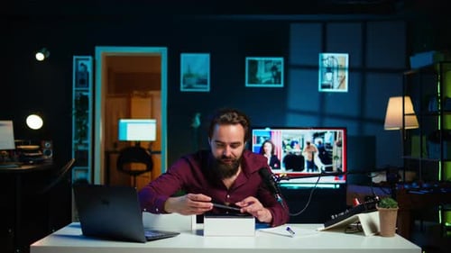 Man Unboxes New Cell Phone in Dark Room