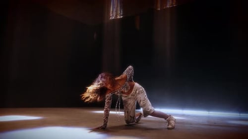 Female Dancer In Studio Spotlight Executing Hip Hop Moves
