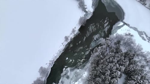 overhead drone shot of a frozen river in norway