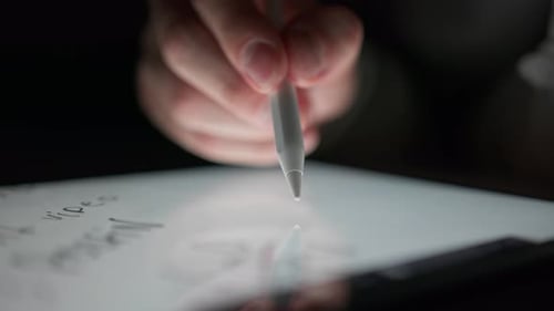 Hand Writes on Tablet With Stylus Pen Close Up