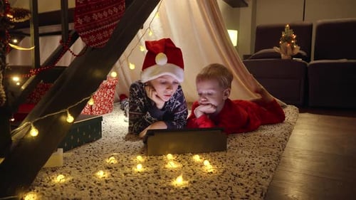 Boys Watching Tablet in Christmas Tent