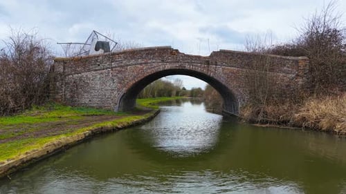 Ancient Brick Bridge Standing Over Flowing Canal Historic Arched Crossing Spanning Across Winding