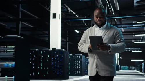 Man with Tablet in a Futuristic Server Room
