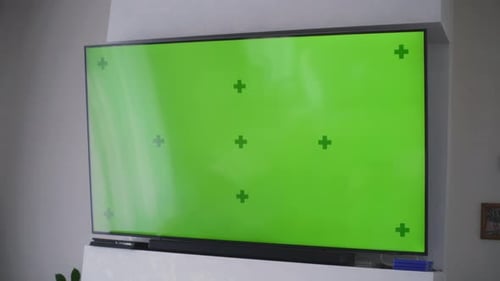 Big TV with Displayed Chroma Key Green Screen on the Wall