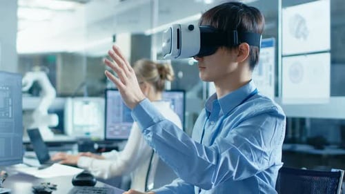 Computer Science Engineer wearing Virtual Reality Headset Works with 3D Modeling, Makes Gestures. I