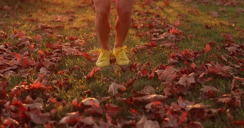 Happy woman jump rope outdoors in autumn park