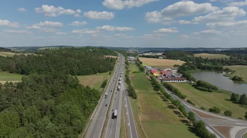 Aerial Forward Flight Over a Line of Trucks on a German Highway in Summer