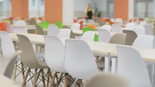 Dining Table Surrounded By Comfortable Chairs in Cafeteria