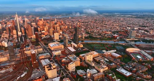 Sunlit Philadelphia panorama at daytime. Drone footage over the vast cityscape at sunset.
