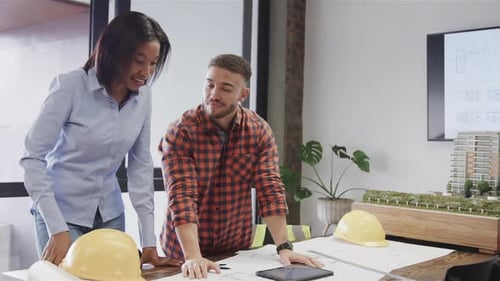 Architects Collaborate on Building Project in Bright Office