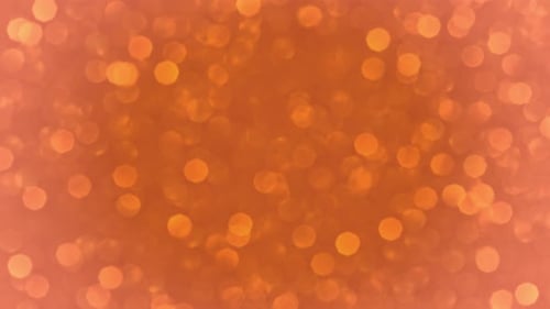 Les lumières bokeh oranges brillent de mille feux