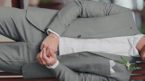 Groom in Suit Buttoning His Jacket