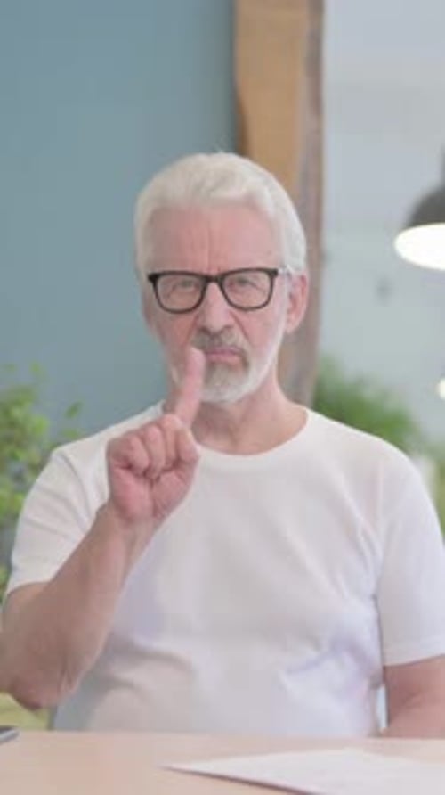 Old Man Denying Offer in Office, vertical video