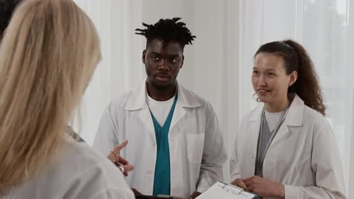 Medical Professionals Discussing Healthcare Information in a Hospital