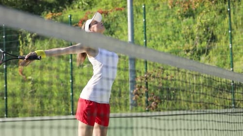 Woman Warming Up for Tennis Match on Court