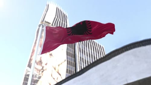 Albania National Flag Waving Over Modern City Buildings