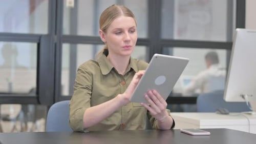 Young Businesswoman Using Digital Tablet in Office